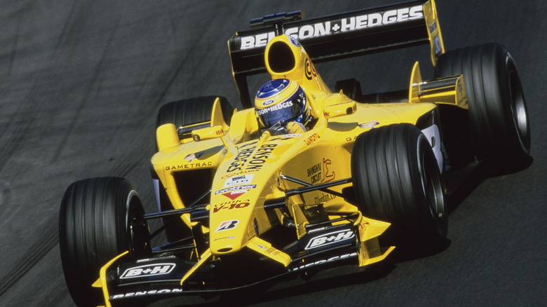 Yellow 2003 Jordan EJ13 on the race-track