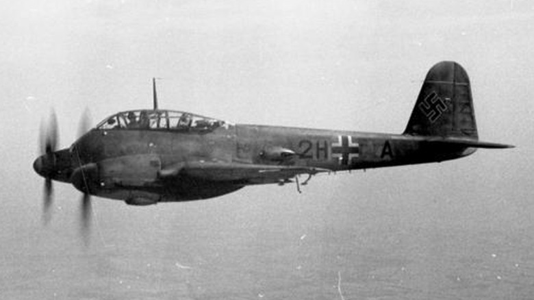 A Messerschmitt Me-210 flying towards the coast over a body of water