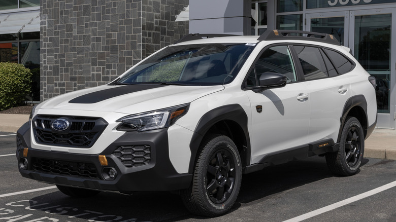 White Subaru Outback Wilderness in parking lot