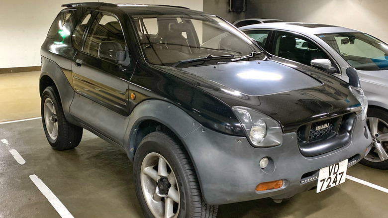 A gray and black Isuzu VehiCross in a parking garage.