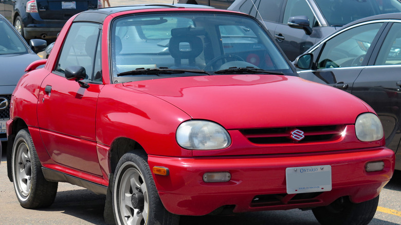 A red 1996 Suzuki X-90 in a parking lot.