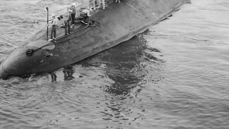 The USS Scorpion with its crew standing on its hull