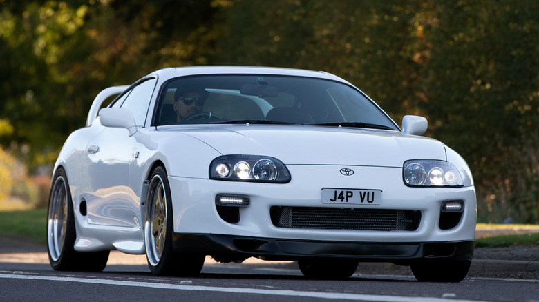 man driving Toyota Supra Mk4