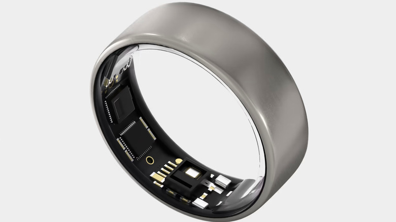 The Ultrahuman Ring Air in its Raw Titanium color option and with its data-collecting sensors showing