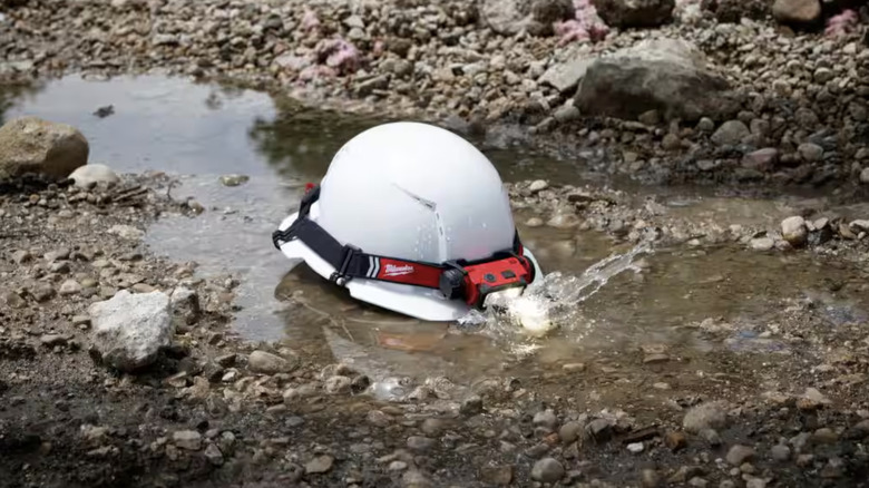 Head lamp on a hard hat in the mud