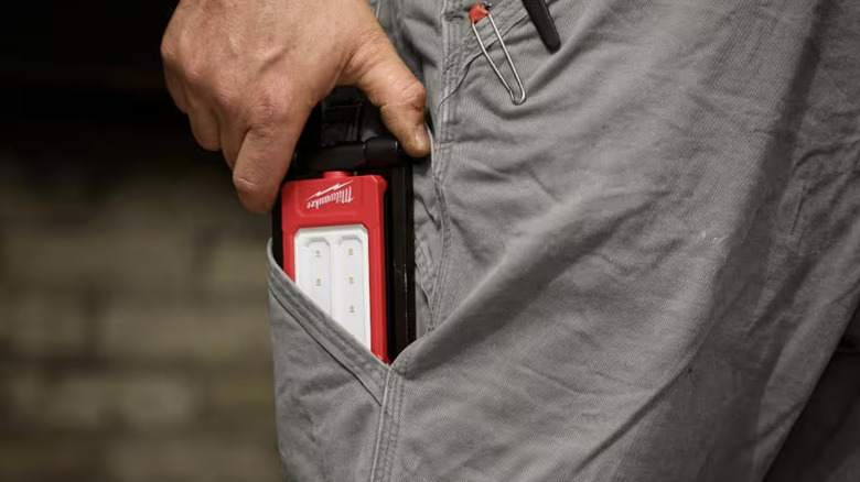 A flat flashlight in a side pocket