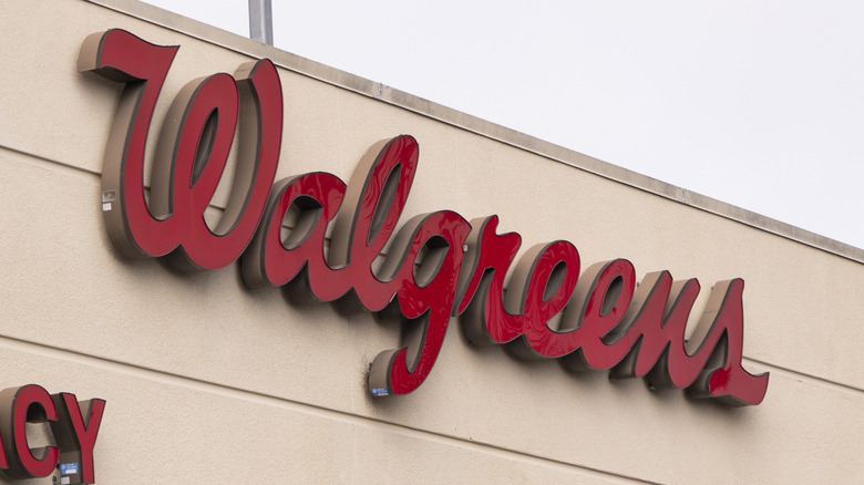 The Walgreens logo on a storefront.