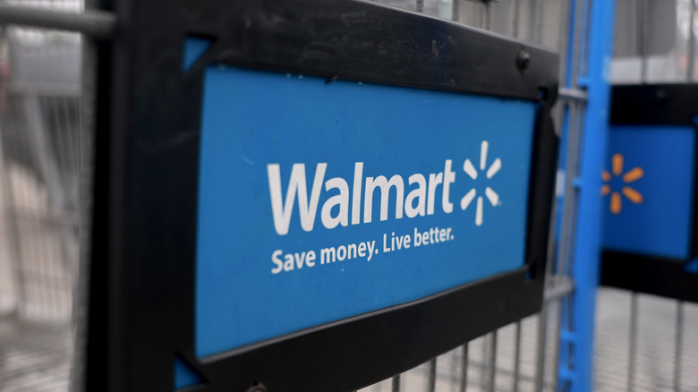 The Walmart logo on the front of a shopping cart.