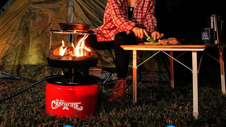 woman cooking using camco fire pit