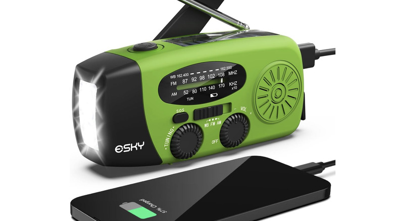 green Esky emergency hand crank radio charging a smartphone device