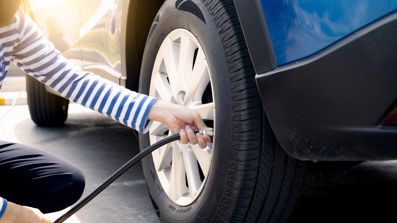 Woman inflating tire