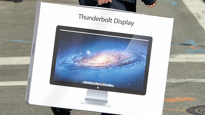 Person carrying Thunderbolt Display box