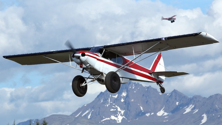 Bush plane landing mountain backdrop