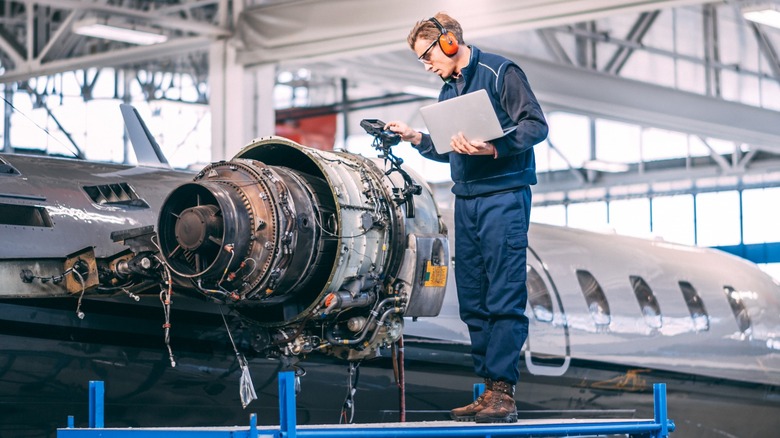 Tech servicing a private jet