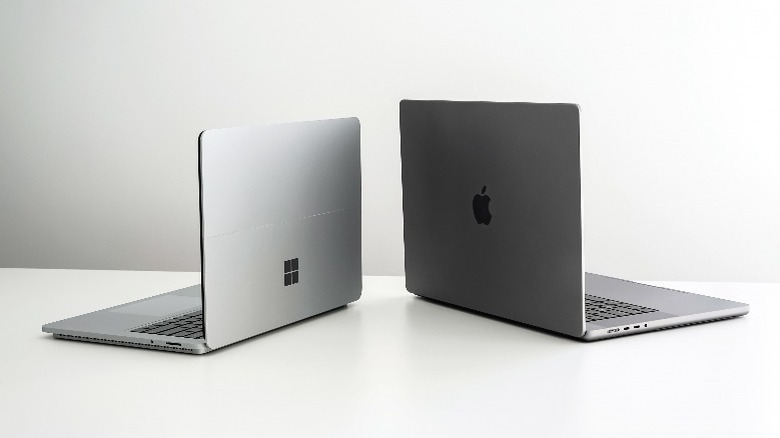 Surace laptop and MacBook beside each other