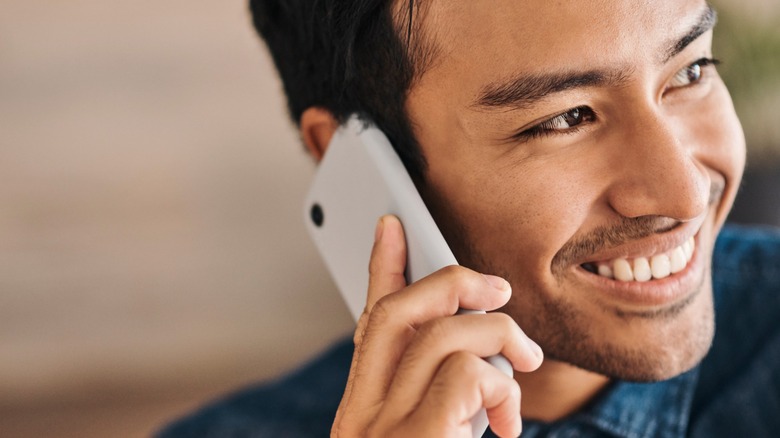 Person holding phone to ear