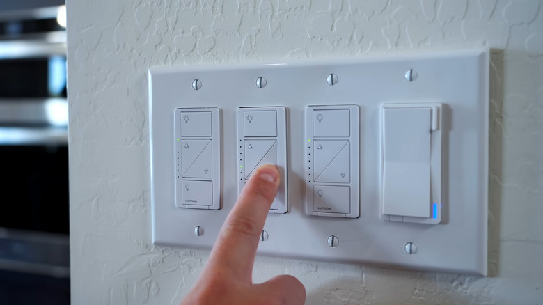 Finger pressing a smart switch button