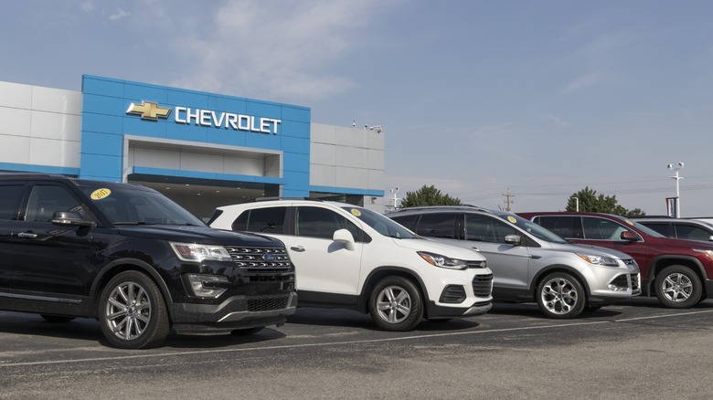 Unsold cars in front of a Chevrolet dealership