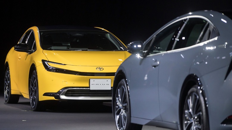 A yellow Toyota Prius on a stage