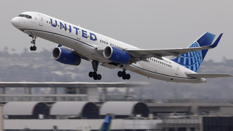 A United Airlines Boeing 757 takes off from an airport