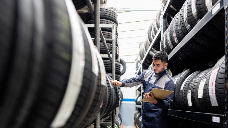 Latin American man looking at tires