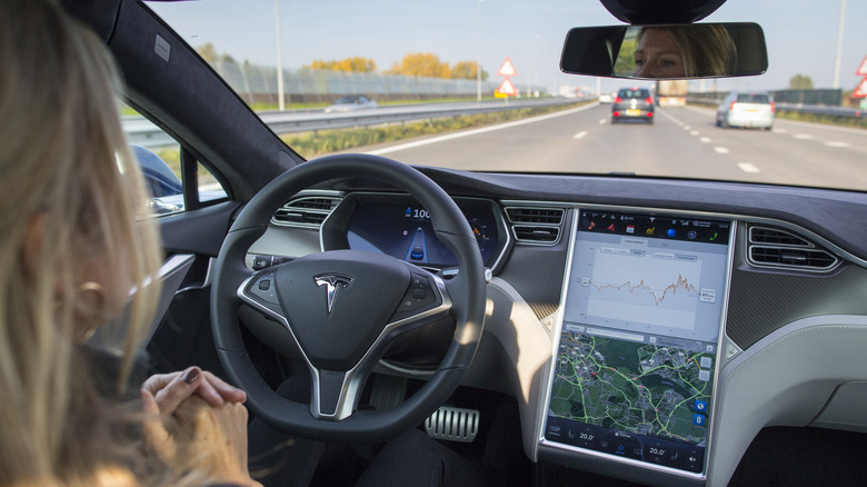 Tesla car dashboard in autopilot