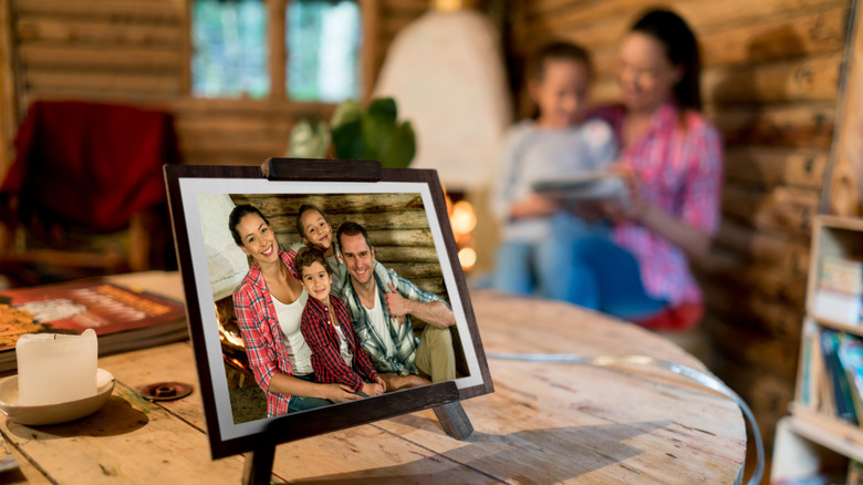 Family photograph in frame with family in background