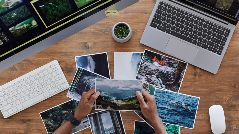 Computers with printed photos on desk