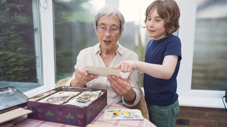 Grandmother and grandson looking at photographs