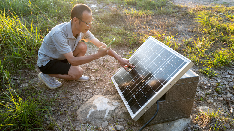 Man and solar panel