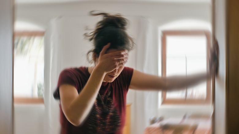 woman holding her head