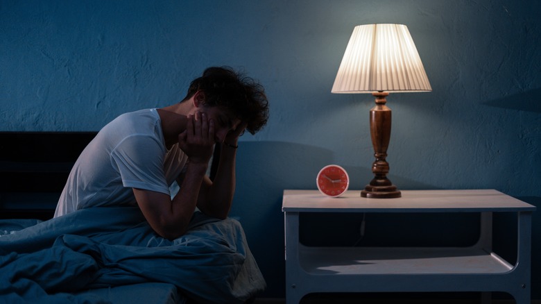 man sitting up in bed