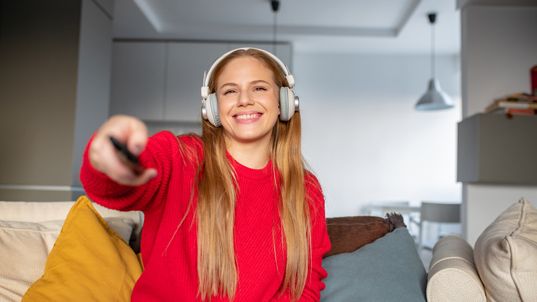 lady watching TV with headphones