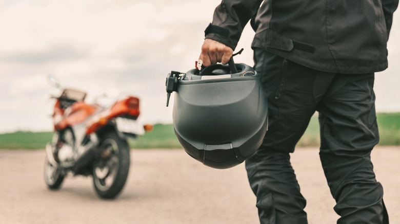 A man approaching a sport bike