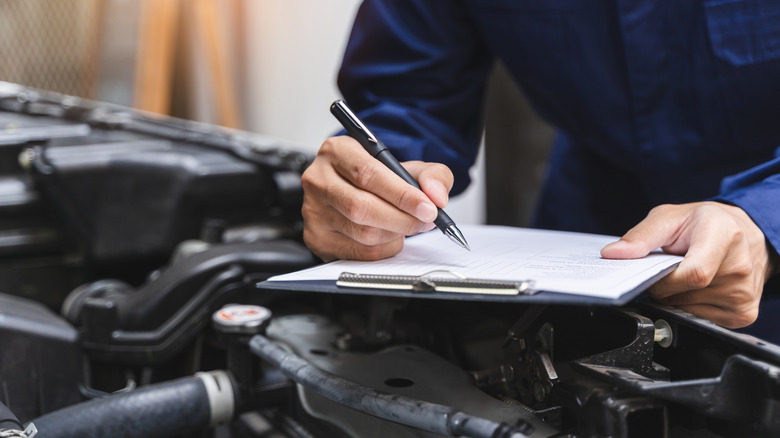 Auto worker with clipboard