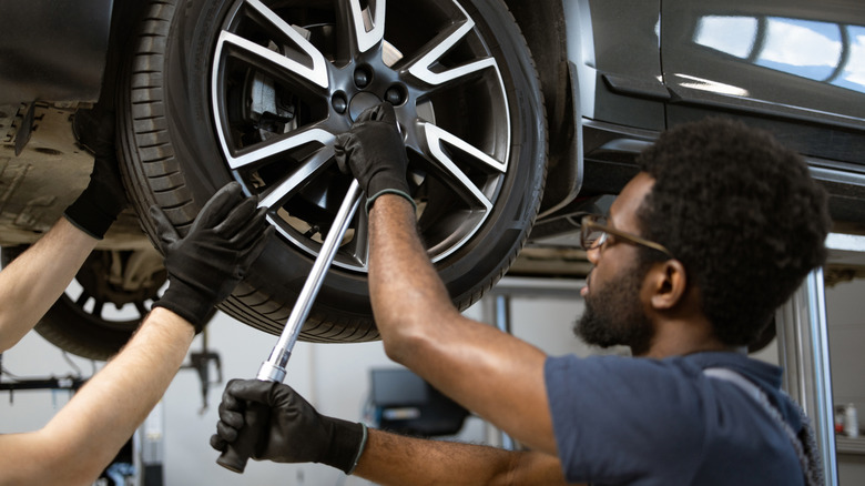 Mechanics working on car wheels