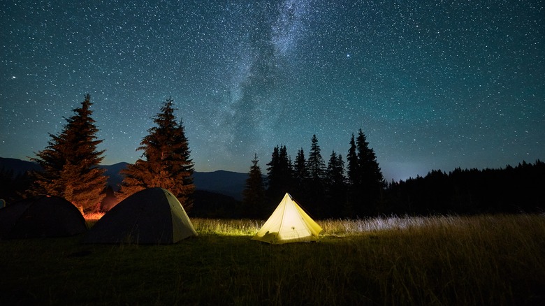 Camping tent in mountains at night