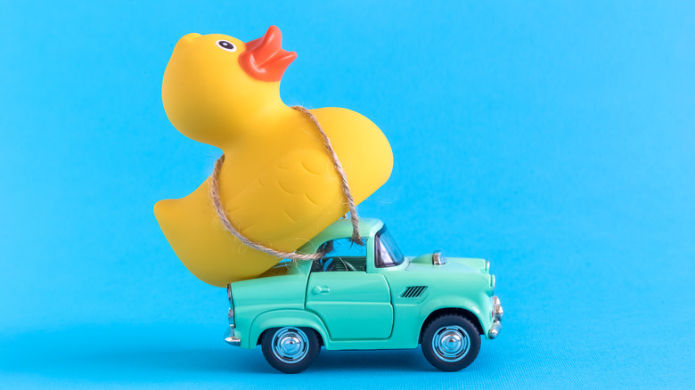 Rubber duck tied to small car toy