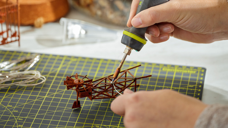 person using ryobi soldering pen