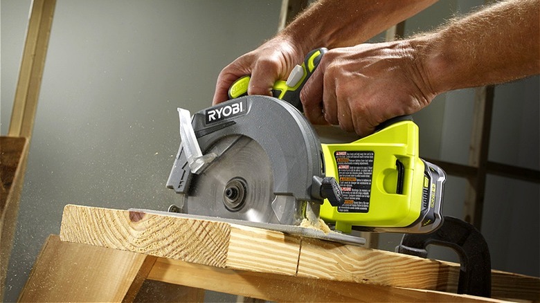 Person using Ryobi circular saw