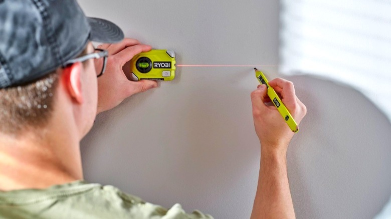 Person using Ryobi laser level