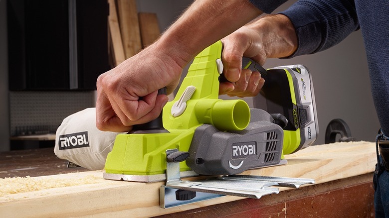 Person using a Ryobi 18V One+ 3¼-inch Planer