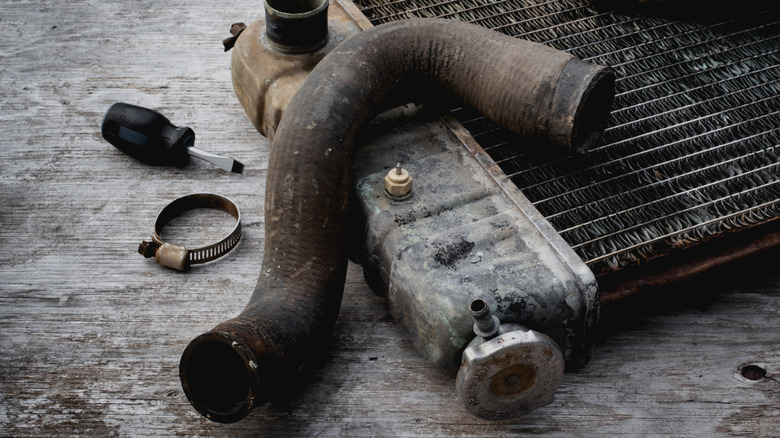 Old radiator hose removed from an engine