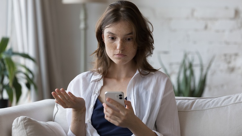 Woman looks at phone