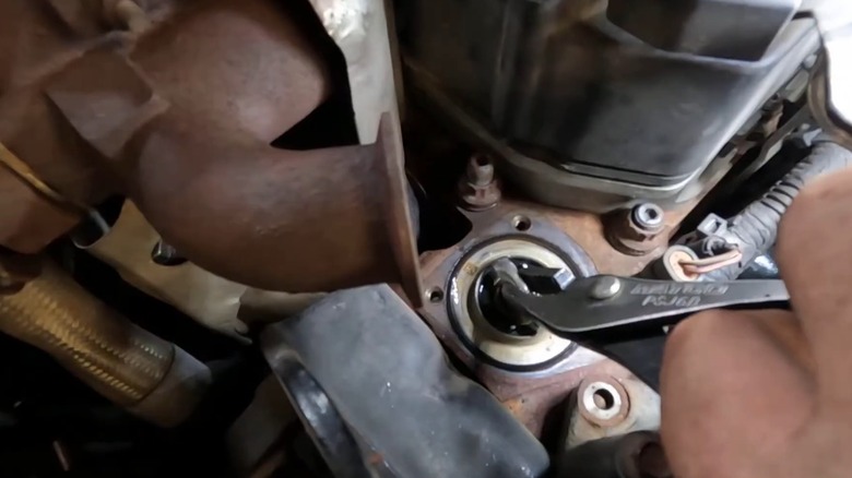 a person replacing the thermostat in their ram cummins engine