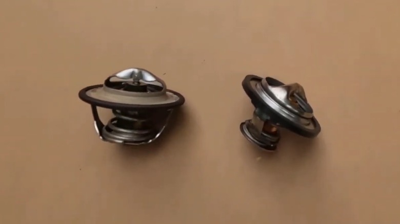 An old (left) and new (right) thermostat for a ram cummins diesel engine