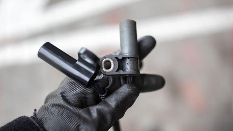 person holding crankshaft position sensors