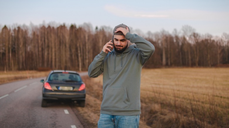 person with broken down car