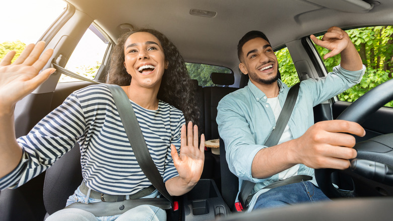 Driver and passenger listening to music