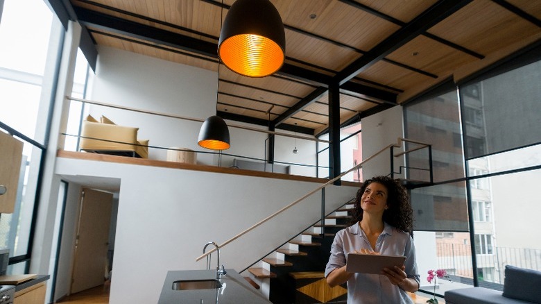 Woman controlling lights using a tablet